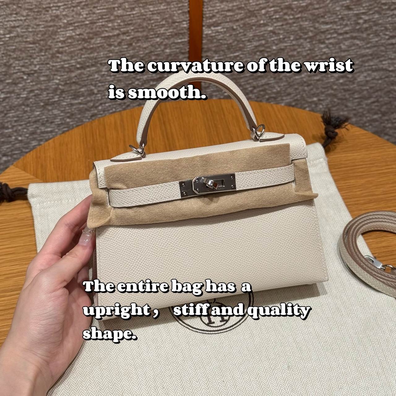 Cream custom leather top-handle bag, front view